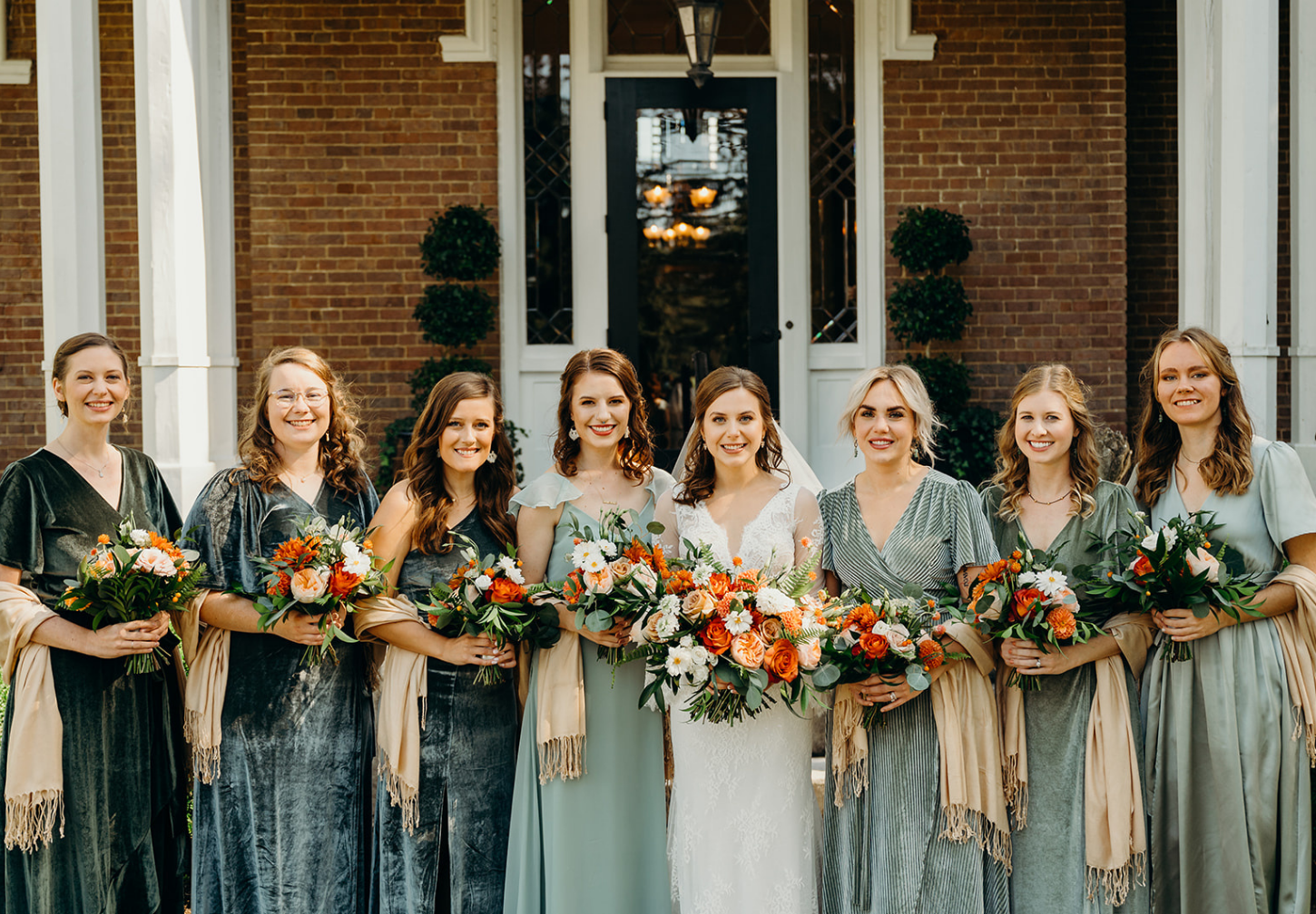 Bride and bridesmaids in front of historic house